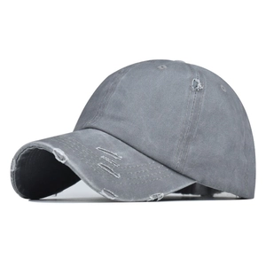 Detail of grey washed cotton baseball cap with distressed torn fabric and street style edge