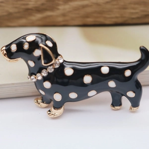 Macro detail of enamel dachshund brooch with gold plating and sparkling rhinestones