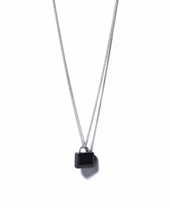Close-up of a 925 sterling silver necklace with a polished square black zircon pendant
