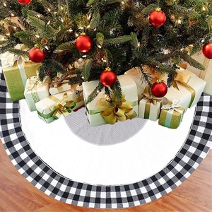 Detailed view of a buffalo plaid Christmas tree skirt under a decorated holiday tree