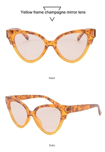 Détail de lunettes œil de chat avec monture en écaille jaune et verres miroir champagne