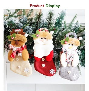 Detailed view of three festive plush mini stockings with Santa, Reindeer and Snowman designs