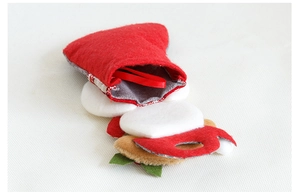 Detail of red Christmas stocking ornament with gray soft interior and hanging ribbon