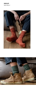 Detail of ribbed knit cotton socks in vintage brick red and olive green tones