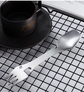 Macro detail of stainless steel 5-in-1 camping utensil with fork spoon and bottle opener