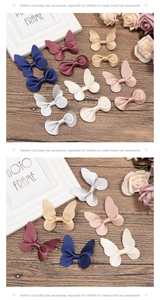 Detail of lychee textured leather butterfly hair clips in various colors for girls