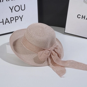 Close-up of fine woven straw texture and elegant bow ribbon on summer beach sun hat