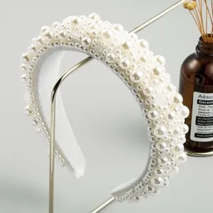 Detailed view of handmade thick white headband with layered faux pearls and soft velvet lining