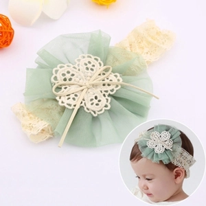 Detail of light green mesh flower and beige lace headband for infant girls' hair