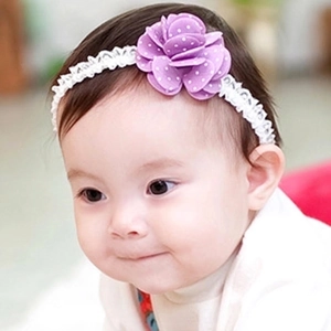 Detail of baby elastic white lace headband featuring a purple polka dot chiffon flower