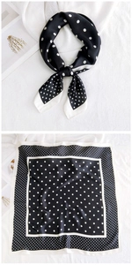 Detailed view of black and white polka dot square silk scarf with satin finish