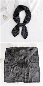 Detail of a square silk scarf with black and white geometric patterns and smooth texture