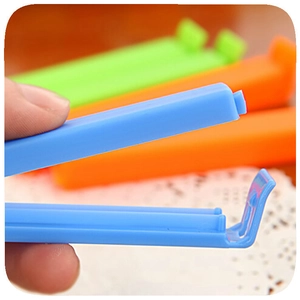 Five-pack 11cm plastic food sealing clips in vibrant blue, green, and orange colors