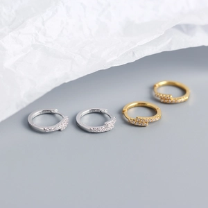 Macro shot of silver and gold S925 sterling silver hoop earrings with paved cubic zirconia