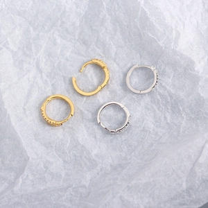 Detailed view of silver and gold S925 sterling silver hoop earrings with cubic zirconia