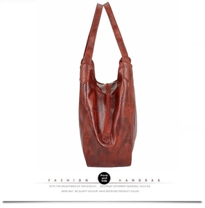 Side view detail showing the pebbled leather texture and base width of the brown tote bag