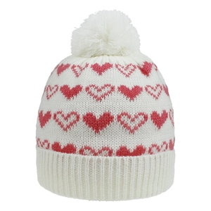 Close-up of kids white knit hat with pink heart patterns and fluffy pompom detail