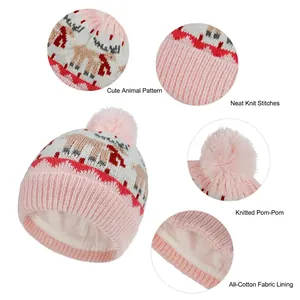 Kids pink knit beanie with reindeer jacquard pattern, soft cotton lining and pompom