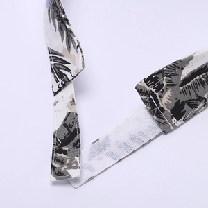 Adjustable floral marathon visor with tropical palm leaf print and velcro strap detail
