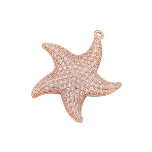 Macro shot of rose gold starfish pendant with cubic zirconia inlay for jewelry making