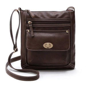 Detail of dark brown leather crossbody bag featuring gold zippers and turn-lock closure