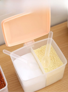 Dual-compartment kitchen seasoning box with orange flip lid and transparent spoons