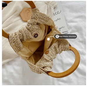 Detailed interior of woven handbag with wooden handle and magnetic snap closure