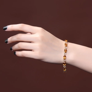 Elegant gold plated bracelet with oval yellow citrine stones and white accent gems