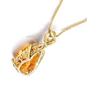 Golden necklace with oval amber gemstone in fine filigree setting on white background