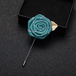Handmade dark teal fabric rose brooch with gold leaf and metal pin on gift box