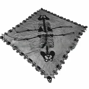 Close-up of black lace Halloween cape featuring a central skeleton and skull border