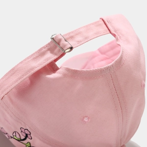 Detail of pink canvas baseball cap with metal buckle and floral embroidery accents