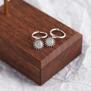 Detailed view of S925 sterling silver sunflower earrings with sparkling center stones