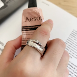Close-up of a minimalist irregular 925 silver ring with a liquid lava texture finish
