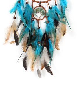 Close-up of a handmade dream catcher featuring a wire tree of life and colorful feathers