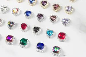 Macro shot of colorful heart and square crystal nail charms with sparkling metal settings