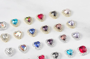 Close-up of heart and square crystal nail rhinestones with small zircon border