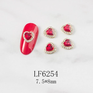 Macro detail of red heart nail art rhinestones with gold alloy base and white diamonds