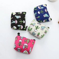 Close-up of small canvas coin purses with cute cactus prints and durable metal zippers