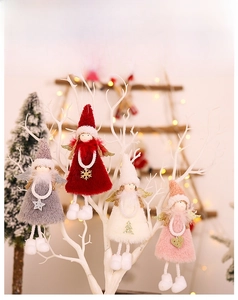 Detail of four plush Christmas angel ornaments with glitter wings and festive charms