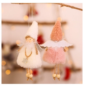Close-up of plush Christmas angel dolls in pink and beige with glitter stars
