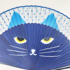 Detail of blue Japanese folding fan featuring cute cartoon cat print and bamboo ribs