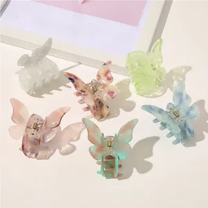 Detailed set of six butterfly hair claws in premium acetate with marble texture