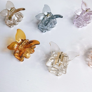 Collection of butterfly hair claws in amber, blue and purple on white background