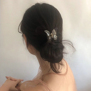 Minimalist transparent butterfly hair claw clip shown styling a high ponytail on model
