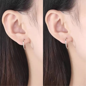 Close-up of high-polish S999 silver hoop earrings on model showing minimalist style