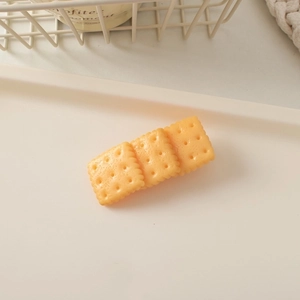 Close-up of cute simulation soda biscuit hair clip with realistic cookie texture