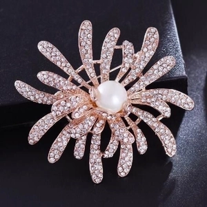 Luxury rose gold fireworks brooch with pearls and crystals on a black display box