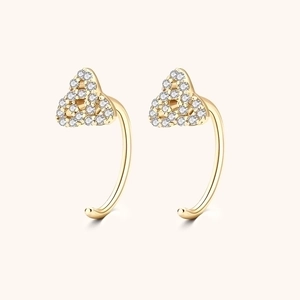 Close-up of gold moissanite earrings with cluster of small white zircons in C-shape