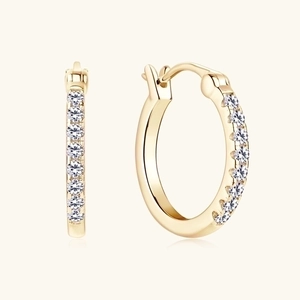 Macro view of gold hoop earrings featuring meticulous white zircon pavé setting